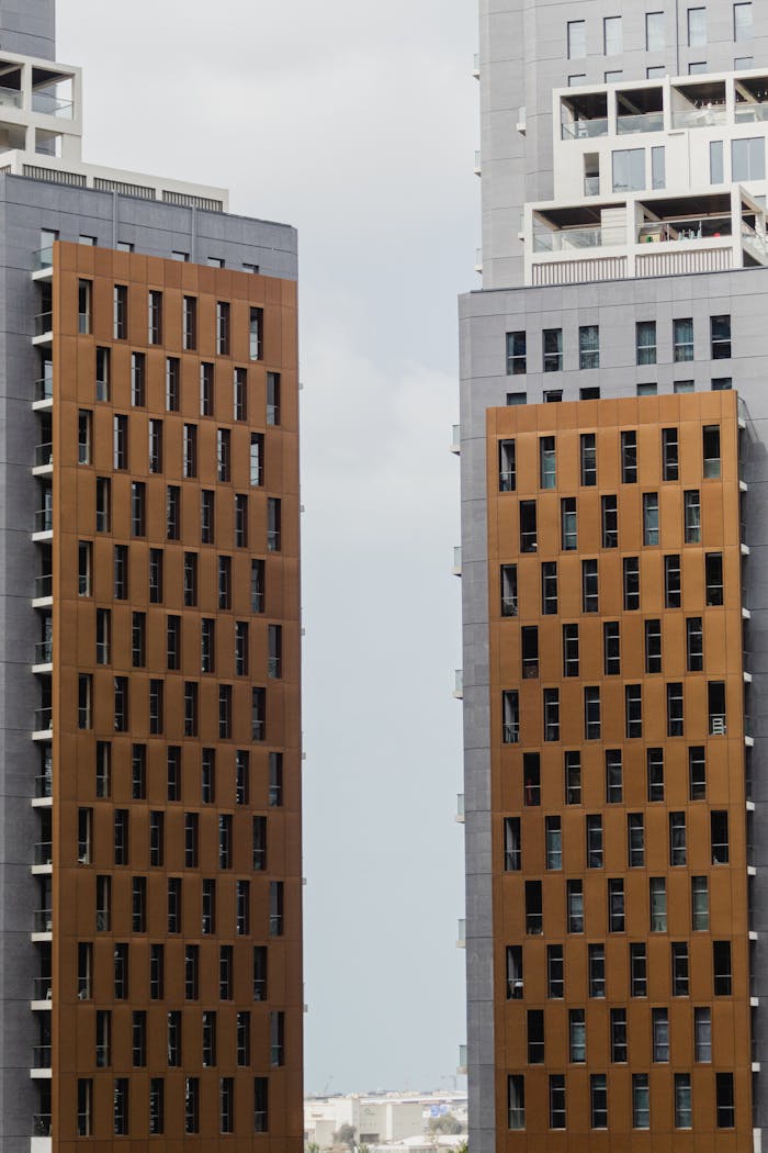 Close-up view of modern skyscrapers with geometrical facades. Perfect for cityscape and architecture themes.