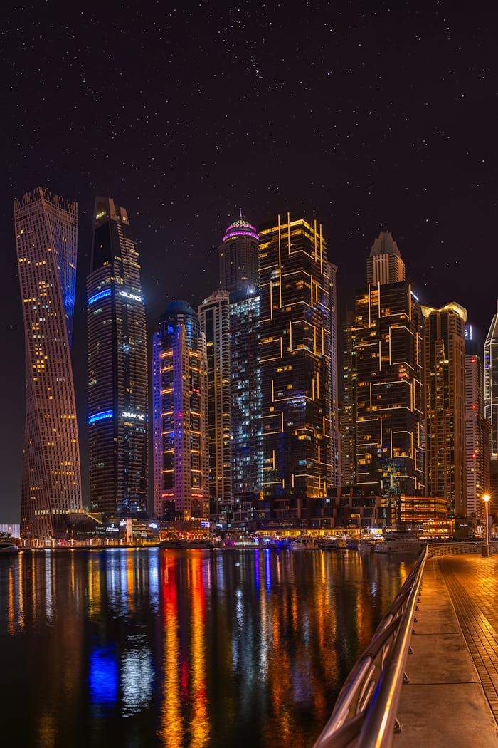 who-we-are Explore the dazzling skyline of Dubai Marina at night, reflecting on calm waters.